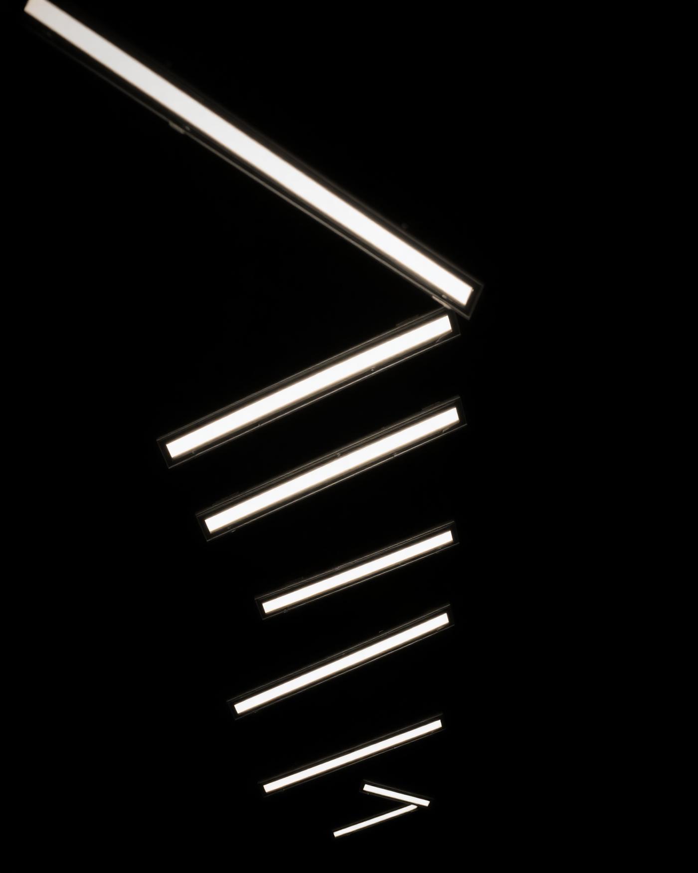 Angular ceiling light fixtures above the barber floor